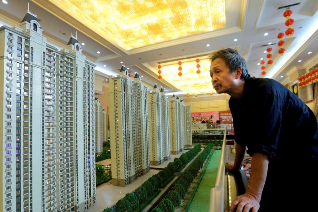 A visitor at a showroom of Evergrande Real Estate Group in Wuhan, Hubei province. The company bought back HK$3.22 billion worth of shares between April 13 and 20. Photo: Reuters