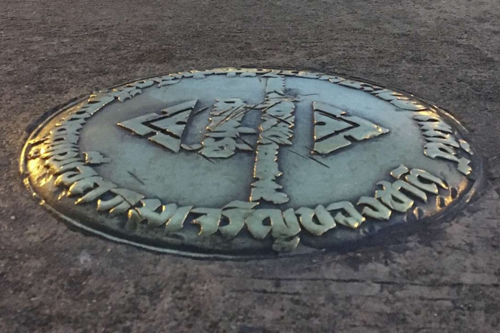 The small bronze plaque commemorating Thailand's 1932 revolution rests in the pavement of the Royal Plaza in Bangkok, Thailand. In early April, the plaque was mysteriously removed by parties unknown and substituted by one praising the Chakri Dynasty, whose 10th king took the throne last December. File photo: AP