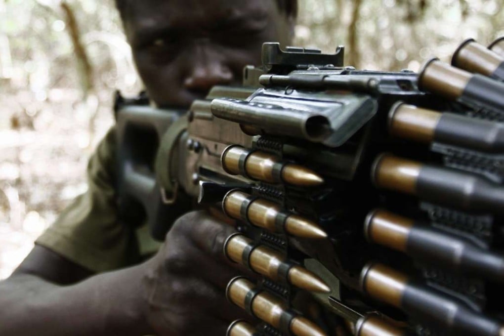 A Ugandan soldier hunting Lord's Resistance Army (LRA) fugitive leaders takes position behind a machine gun in a forest bordering Central African Republic (CAR), South Sudan and Democratic Republic of Congo. File photo: Reuters