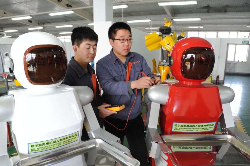 Workers check newly produced service industry robots in Harbin, Heilongjiang province. Photo: China Foto Press