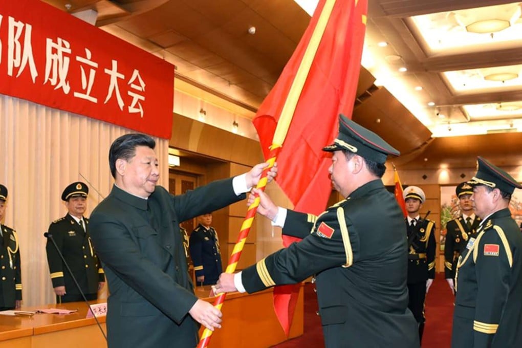 Communist Party general secretary Xi Jinping hands a military flag to the head of the PLA’s ground forces, General Li Zuocheng, last year. Xinhua