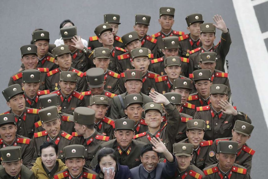 North Koreans soldiers and civilians ride in the back of a truck in Pyongyang during Kim Il-sung's 105th birth anniversary military parade on April 15. Photo: AP