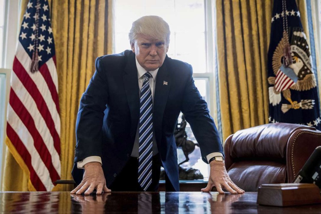 US President Donald Trump poses for a portrait in the Oval Office in Washington, on Friday, April 21. Photo: AP