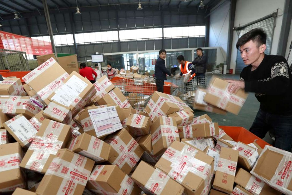Workers prepare boxes for packaging goods for delivery at a sorting center in Lianyungang, in China's Jiangsu province during the Singles Day online shopping festival on November 11, 2016. Chinese shoppers unleashed a record deluge of cash online for Singles Day on November 11, Alibaba said. Photo: AFP