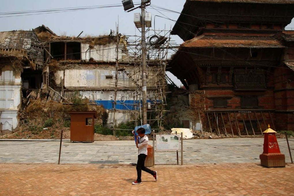 A man walks past Bashantapur Durbar Square, a Unesco world heritage site damaged during the 2015 earthquake, in Kathmandu. Photo: Reuters