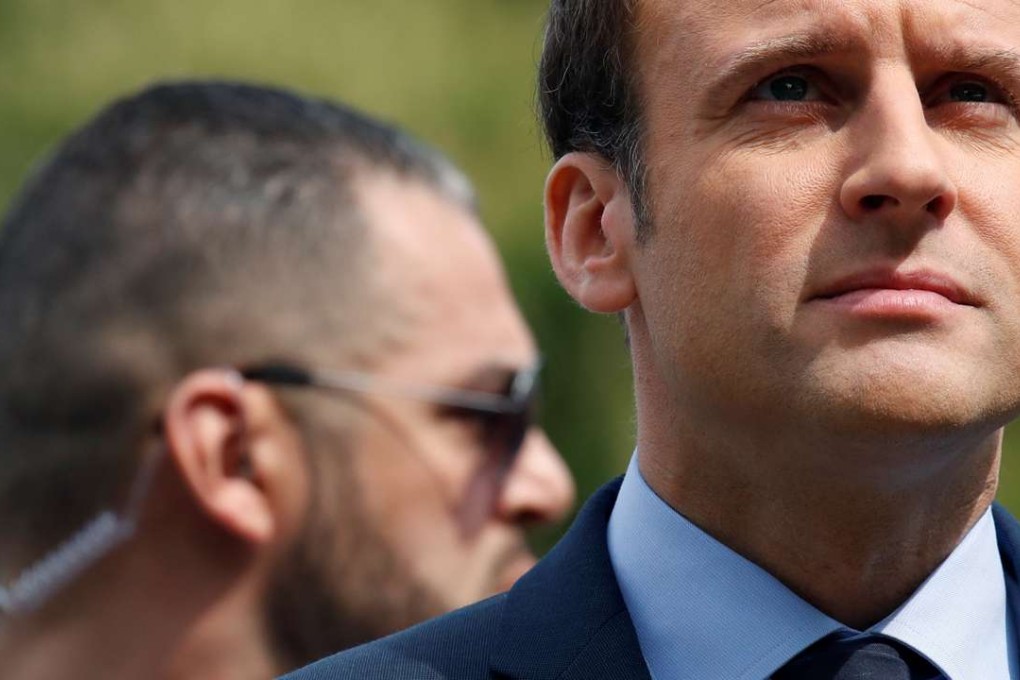 A bodyguard stands near Emmanuel Macron, French presidential candidate, at a ceremony at a monument in memory of mass killings of Armenians by Ottoman forces in 1915, in Paris on Monday. Photo: Reuters