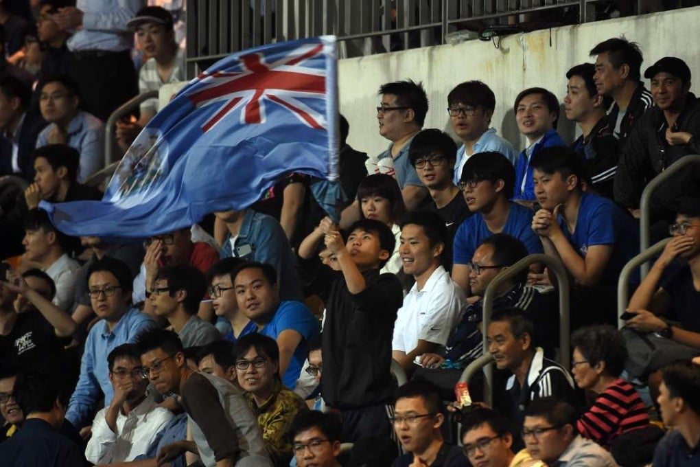 An Eastern fan waves the old British colonial flag of Hong Kong during the AFC Champions League match at Mong Kok Stadium. Photos: AFP
