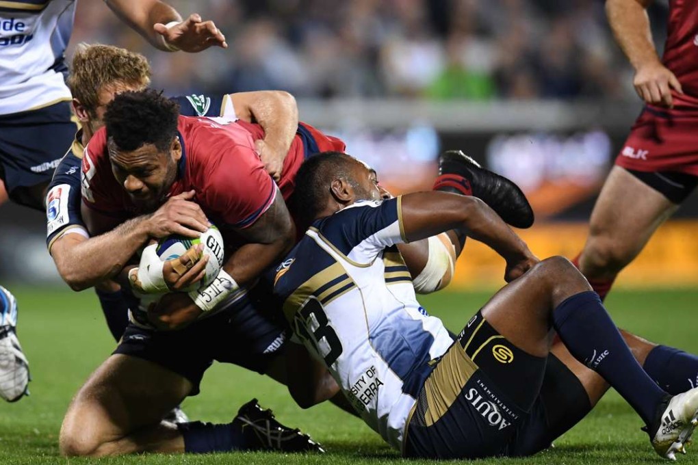 Samu Kerevi of the Reds is tackled by the Brumbies’ Tevita Kuridrani and Kyle Godwin. Photos: EPA