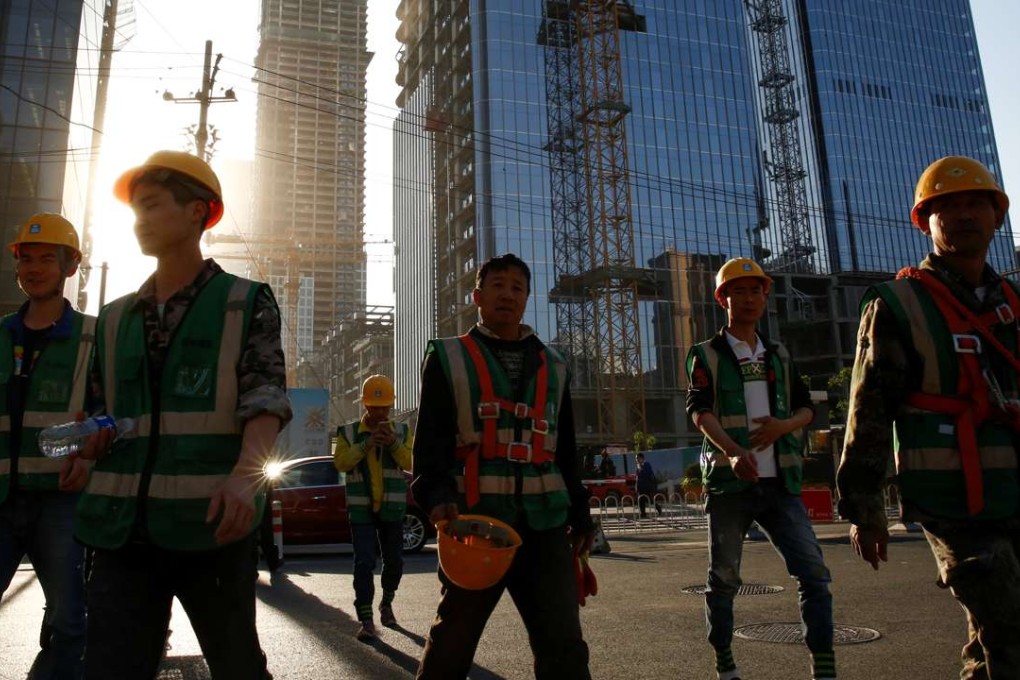 Workers leave a construction site in the central business district in Beijing. Has China played a disproportionate role in reshaping the world economy? Chinese rebalancing suggests that this may well be the case. Photo: Reuters