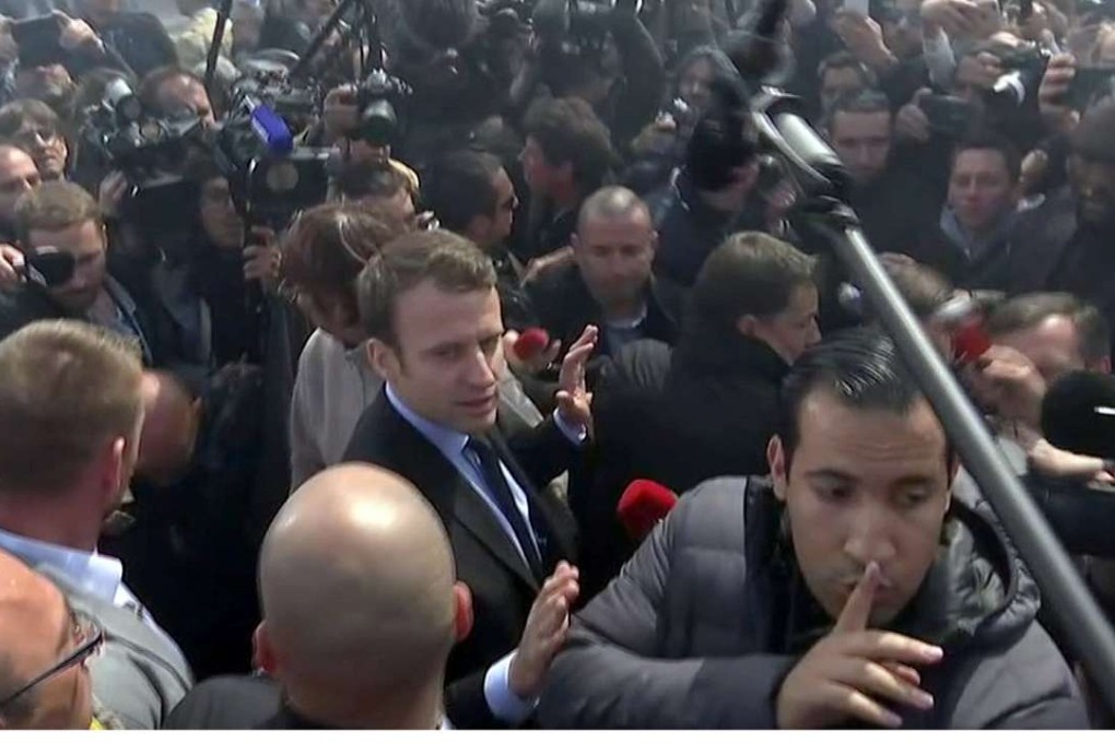 A still image taken from video shows Emmanuel Macron getting heckled as he attempts to talk to Whirlpool employees in front of the company plant in Amiens, France, on Wednesday. Photo: Reuters