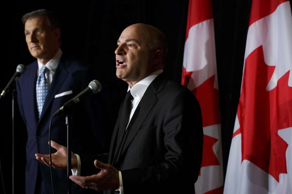 Kevin O'Leary announces his decision to withdraw from the Canadian Conservative leadership race and throw his support behind Maxime Bernier, who looks on during a press conference in Toronto on Wednesday. Photo: Bloomberg