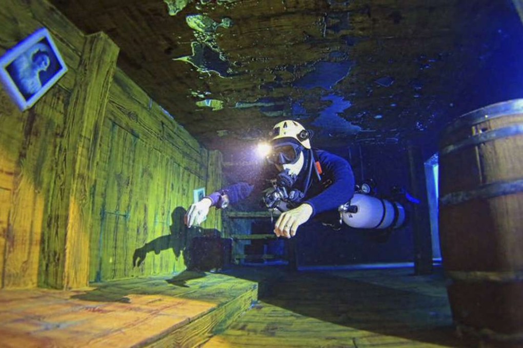 A participant diving in the pool at the Divecube Hotel.
