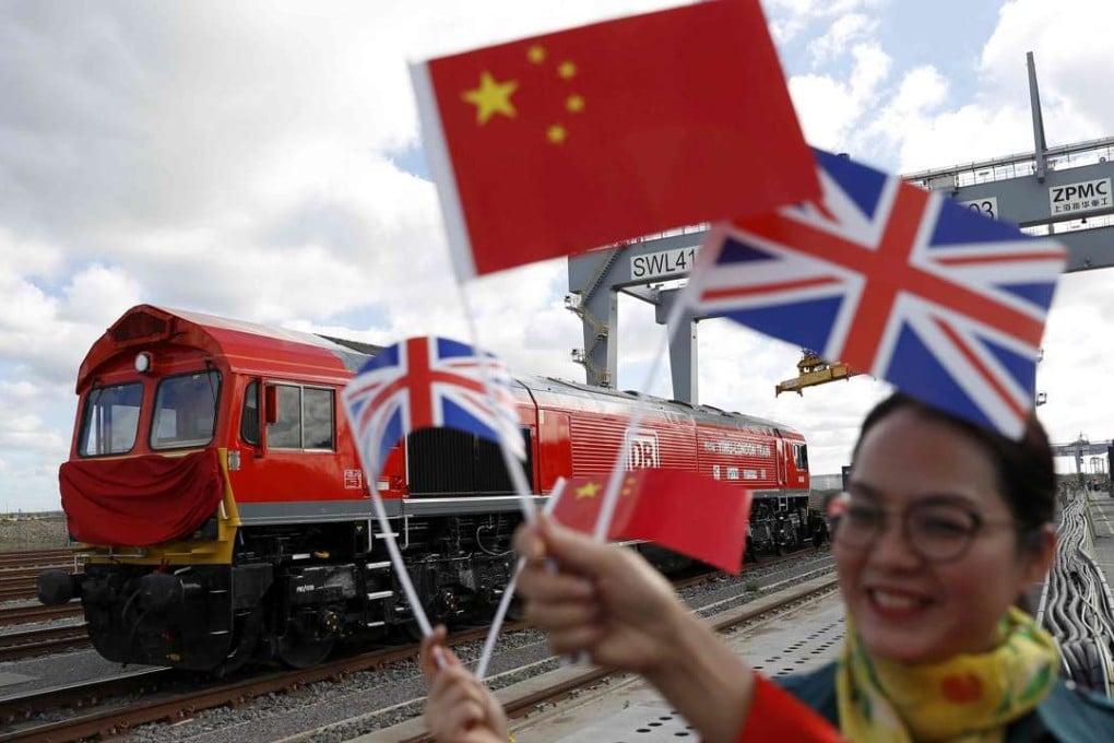 Chinese women wave flags at the official ceremony earlier this month to mark the departure of the first UK-to-China freight train, laden with containers of British goods, from the DP World London Gateway, in Stanford-le-Hope, east of central London. Photo: Reuters