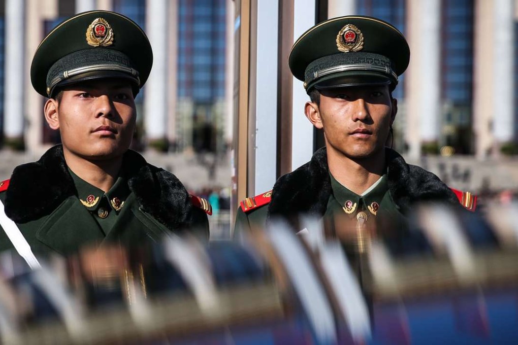 People’s Liberation Army soldiers stand guard in front of the Great Hall of the People in Beijing. Photo: EPA