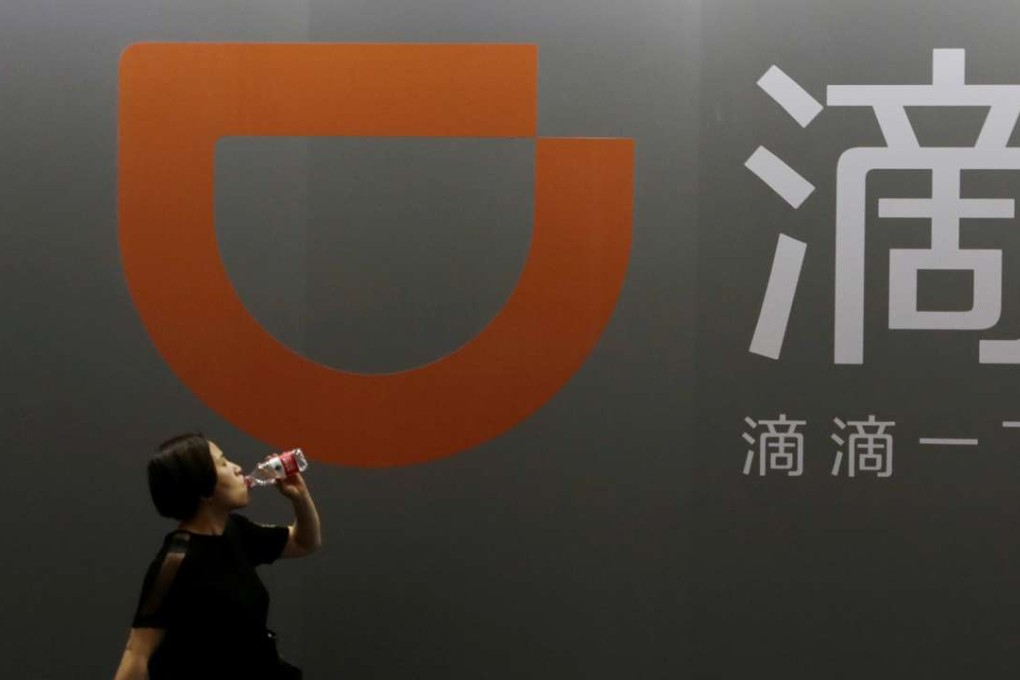 A woman walks past Didi Chuxing's stall at the Global Mobile Internet Conference 2017 in Beijing on Friday. Photo: Reuters