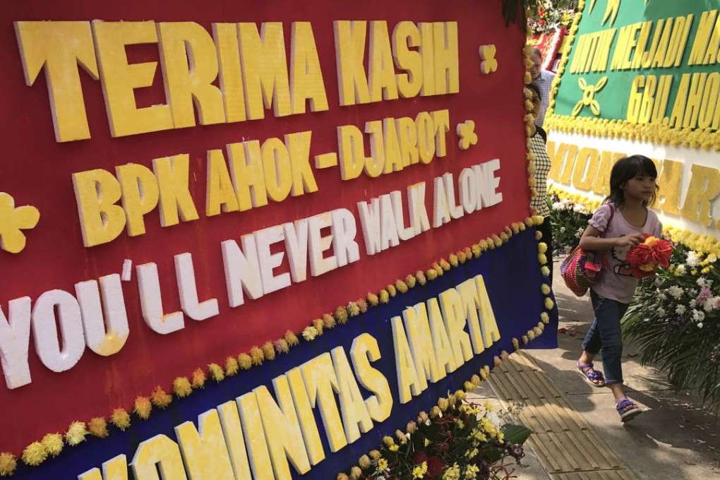 Supporters of Jakarta Governor Basuki Tjahaja Purnama place hundreds of bouquets outside his office after his defeat in the recent election. Photo: Thomas Yau