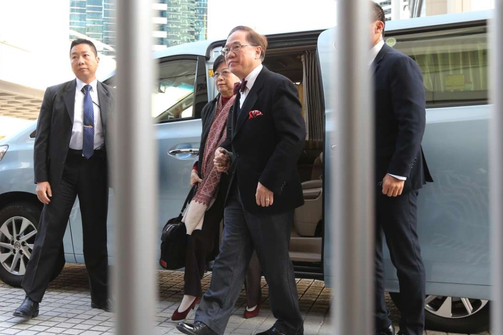 Former chief executive Donald Tsang with his car and bodyguards. Photo: Felix Wong