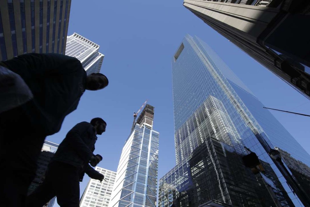 People walk near the Comcast Innovation and Technology Centre under construction, middle, and the Comcast Centre, right, in Philadelphia. US quarterly economic growth in the first quarter of 2017 was at its slowest in three years. Photo: AP