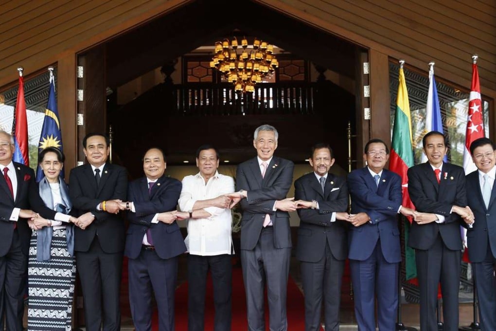 Leaders of Asean countries join hands for a group photograph at their summit in Manila on Saturday. Photo: EPA
