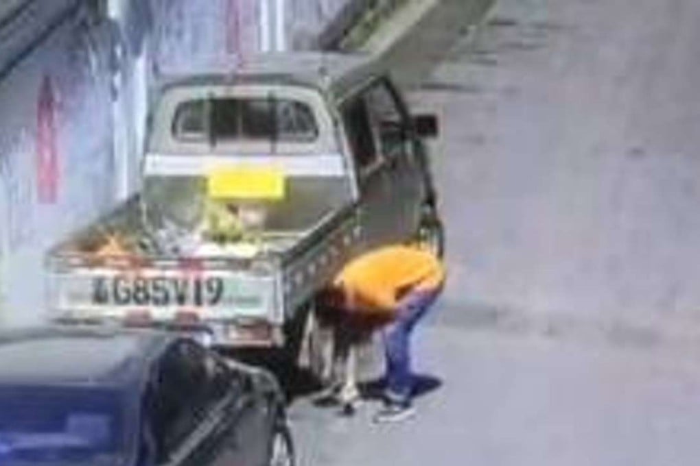 The driver was seen on surveillance footage drawing a parking space around his car on Monday. Photo: Handout