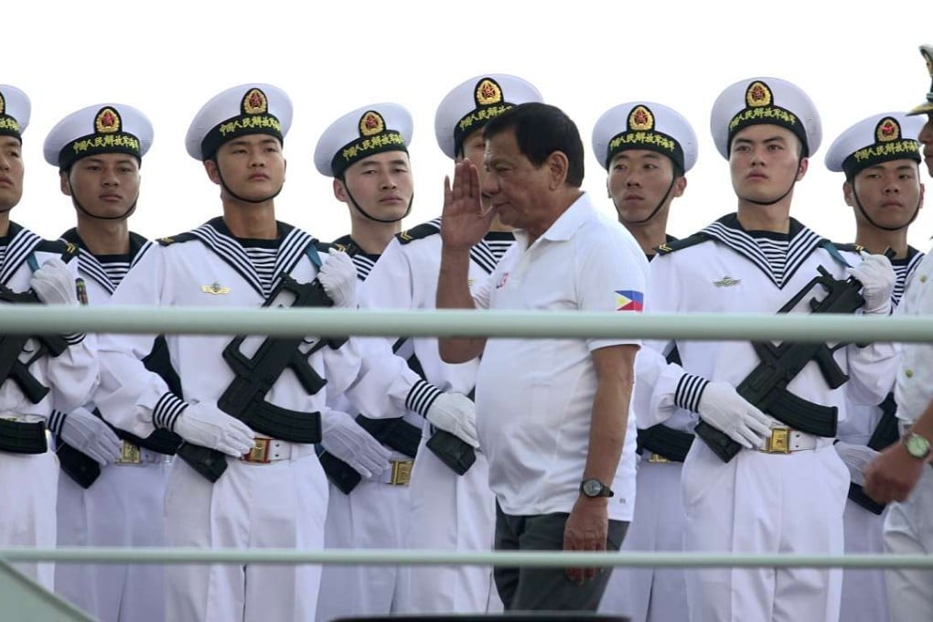 Filipino President Rodrigo Duterte salutes Chinese Navy personnel as he tours a Chinese Naval ship during a visit in Davao city. Photo: EPA