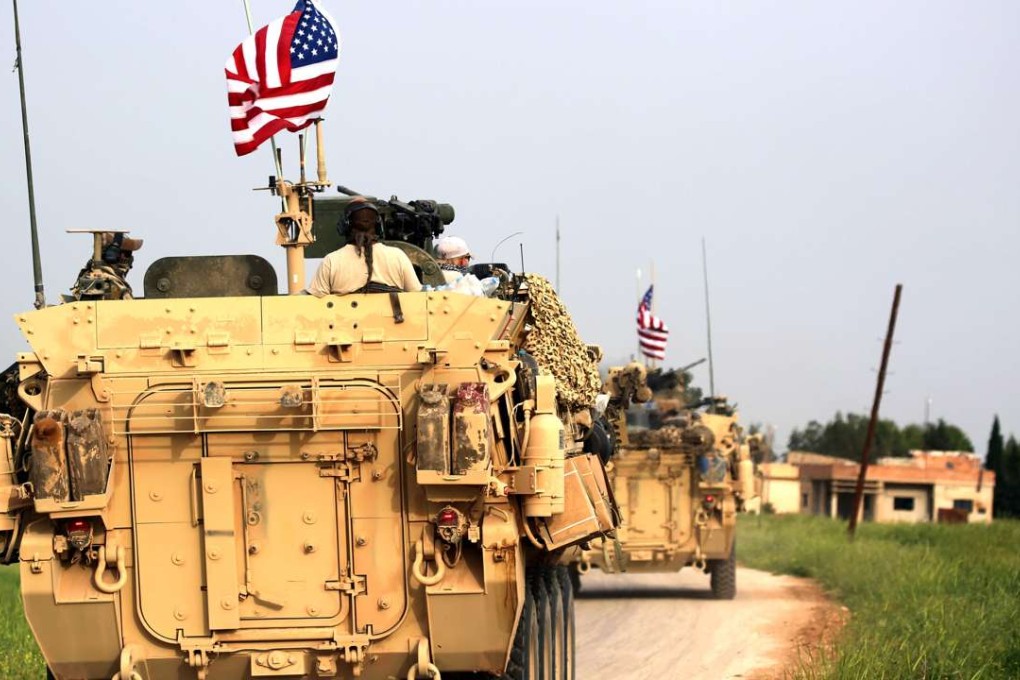 US forces fly the American flag in a convoy accompanied by Kurdish People's Protection Units (YPG) fighters near the northern Syrian village of Darbasiyah, on the border with Turkey on Friday. Photo: AFP