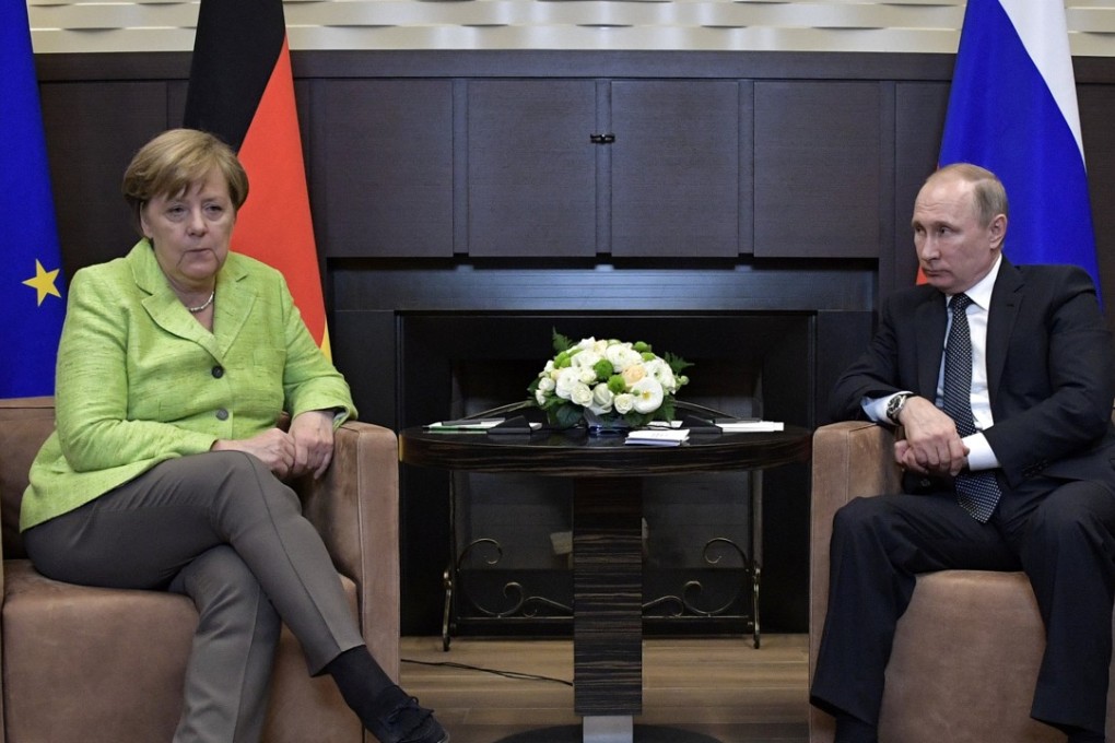 Russian President Vladimir Putin meets with German Chancellor Angela Merkel. Photo: Reuters