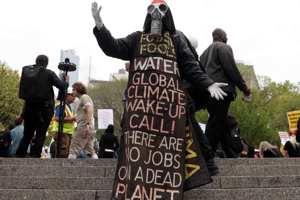 A man wearing a costume for a variety of issues from climate change to food warns of how inaction could threaten the planet. Photo: Reuters