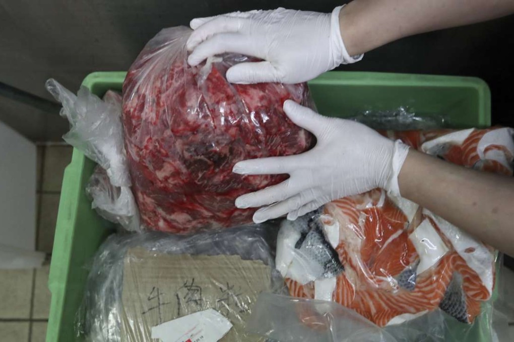 Workers packing excess food to give away to be picked up by Food Link at the Grand Hyatt Hotel. Photo: Nora Tam