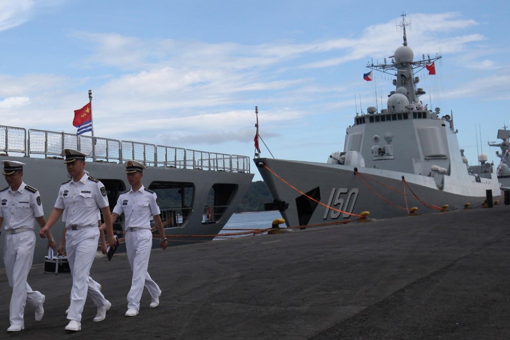 Chinese navy officers walk past a PLA ship during their port call at Davao City in the Philippines. Photo: Reuters