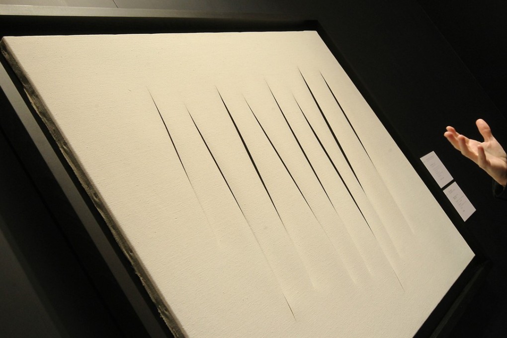 Concetto spaziale, Attese by Lucio Fontana is seen at the Christie's spring 2012 press preview of overseas auction highlights at Hong Kong Convention & Exhibition Centre in Wan Chai. Photo: SCMP Picture