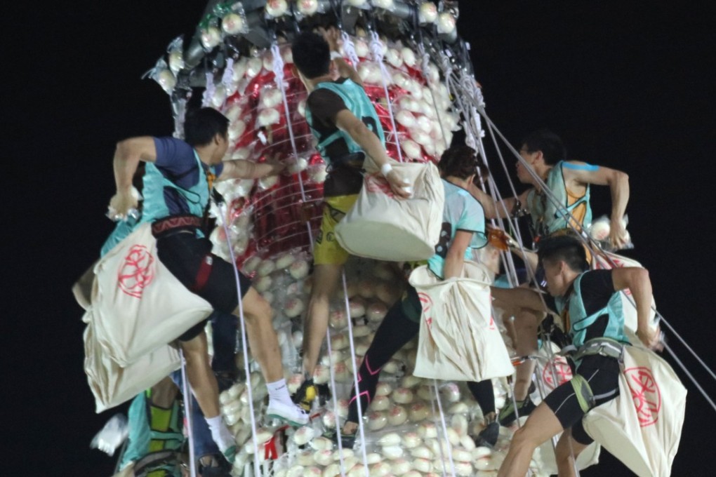 The race up the 14-metre bun-laden tower on Cheung Chau Island started at midnight Thursday. Photo: Felix Wong