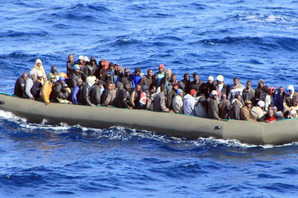 African migrants crowded in a rubber boat near Lampedusa, Italy, in a file photo from February 2014. Photo: EPA