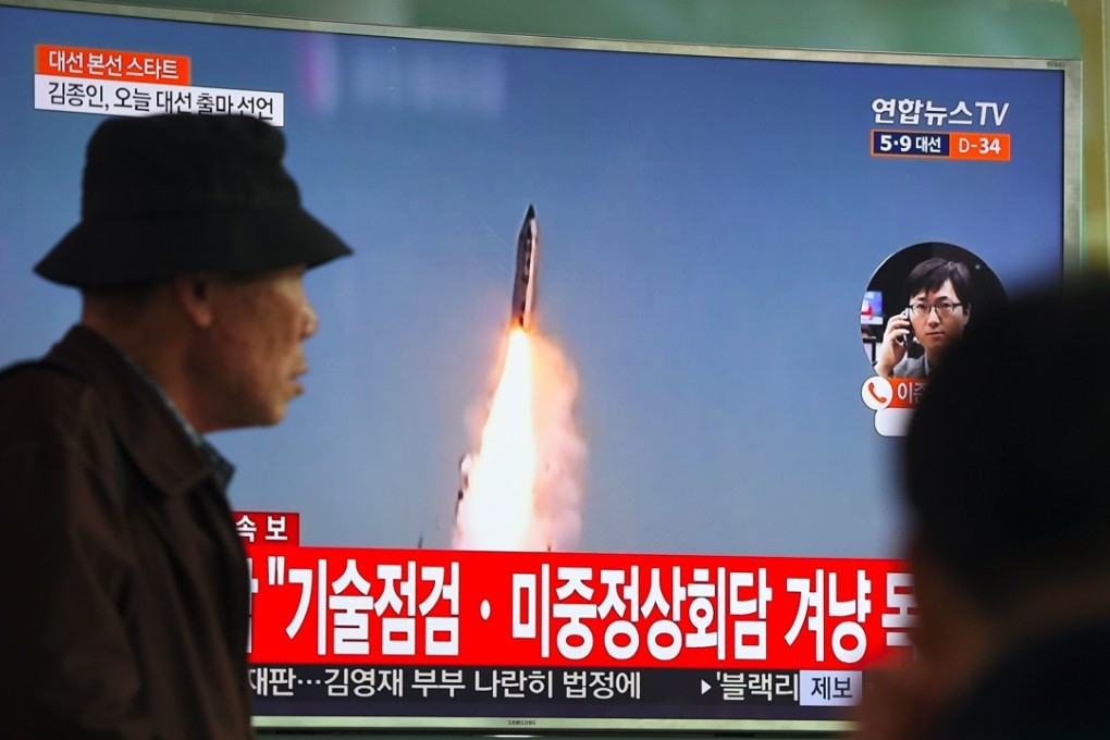 A man walks past a television screen showing file footage of a North Korean missile launch, at a railway station in Seoul last month. Photo: AFP