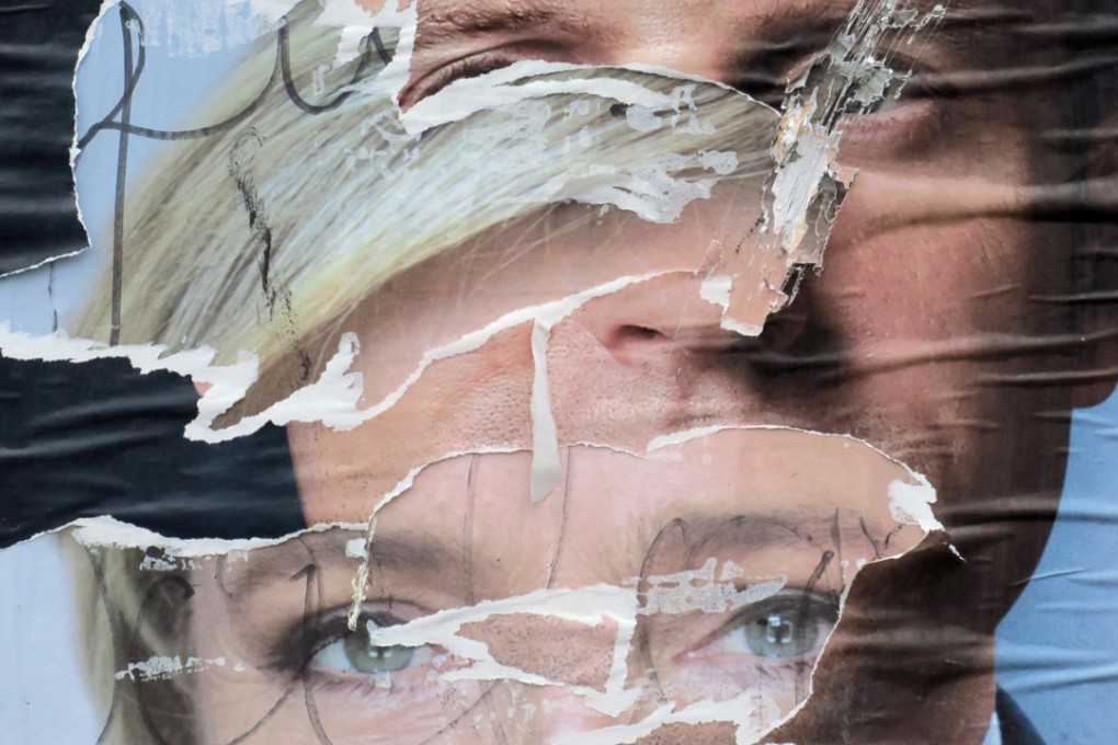 Torn and overlapping official posters of candidates for the 2017 French presidential election Marine Le Pen and Emmanuel Macron are seen in Cambrai, France. Photo: Reuters