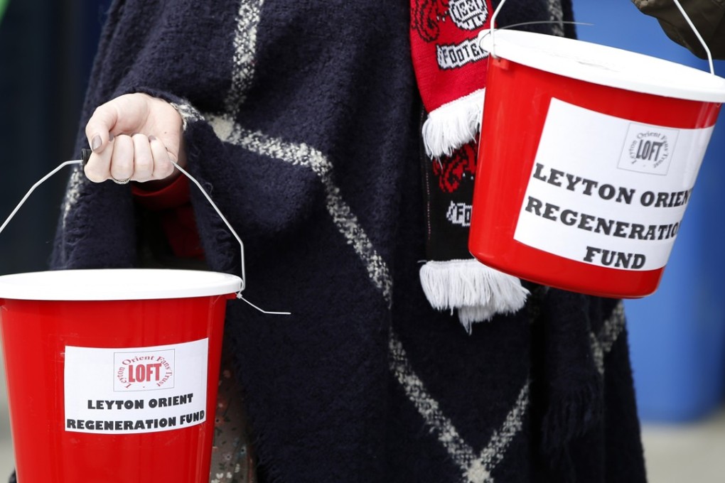 Leyton Orient fans collect money outside the ground. Photo: Reuters