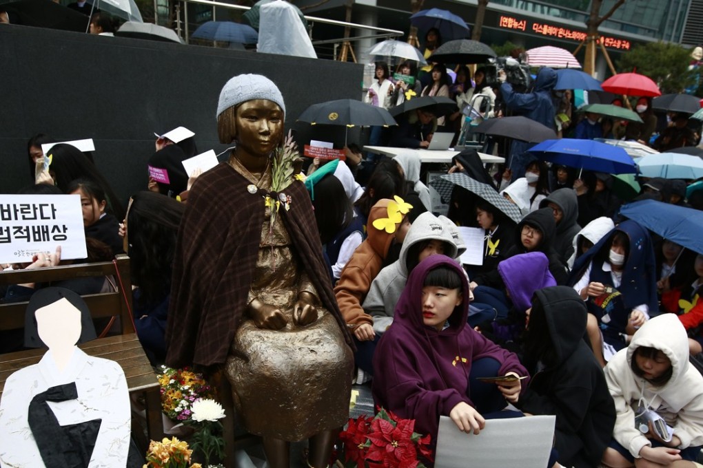 South Korean supporters of former 'comfort women' gather in front of the statue symbolizing a wartime sex slaves at the weekly rally against the Japanese government, near the Japanese Embassy in Seoul, South Korea. Photo: EPA
