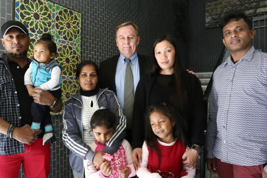 The refugees who sheltered Edward Snowden in Hong Kong with lawyer Robert Tibbo. Photo: Jonathan Wong