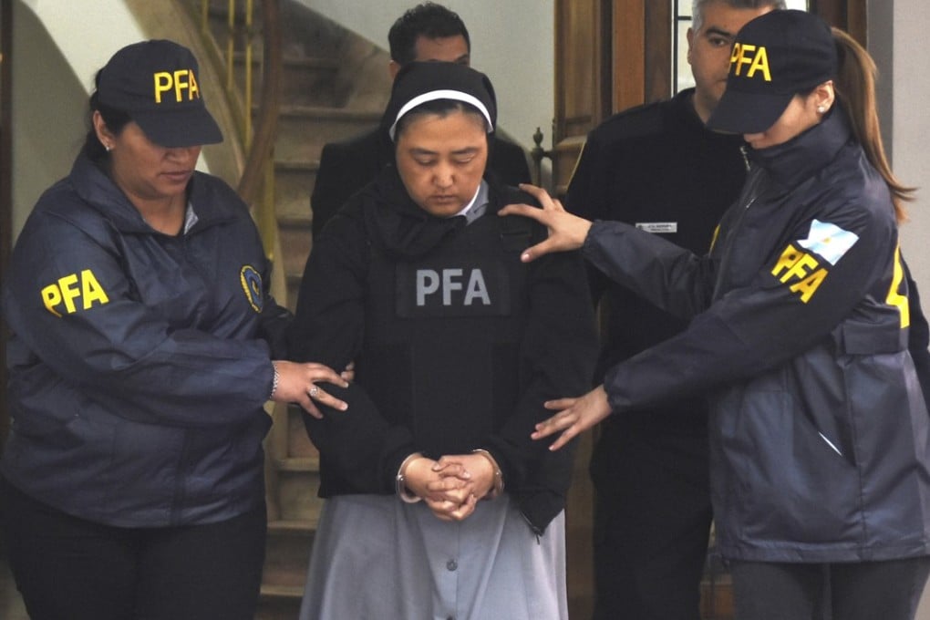 Roman Catholic nun Kosaka Kumiko is escorted out of a police station. Photo: AP