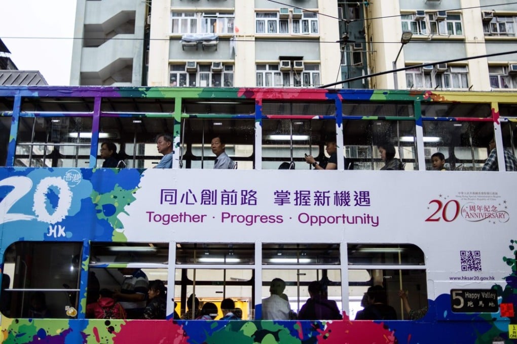 Hong Kong commuters travel on a tram with a design commemorating the 20th anniversary of its return to Chinese sovereignty. The obsession with safeguarding the city’s pre-1997 lifestyle and separate systems has blinded Hong Kong’s leaders to the profound and systemic technological change taking place in the rest of the world. Photo: AFP