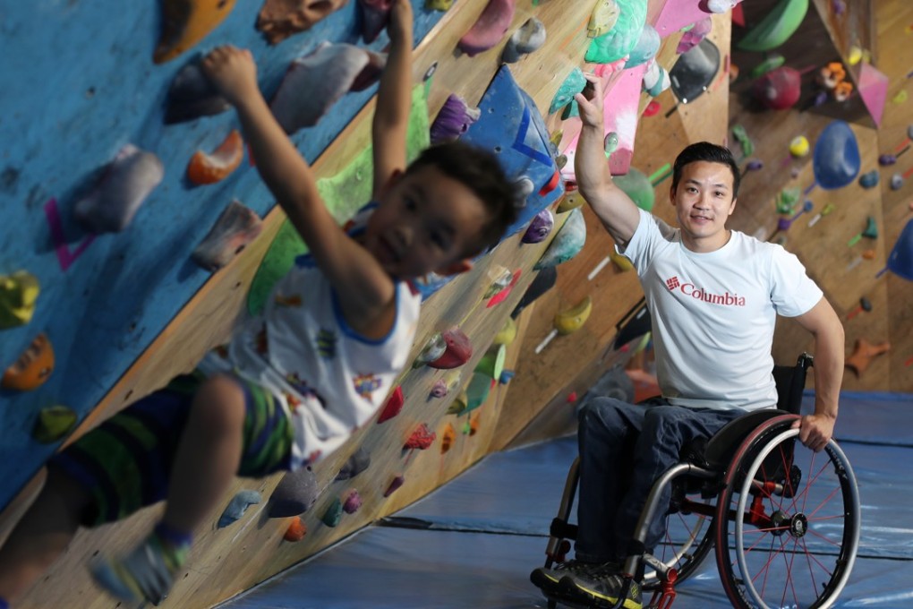 Rock climber Lai Chi-wai with his son Gordon at San Po Kong indoor gym Just Climb. Photo: Nora Tam