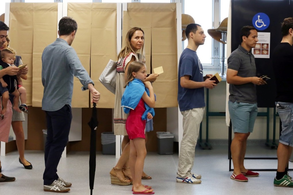 Voters in Hong Kong lining up to cast their ballots in the second round of the French presidential election at a polling station inside the French International School on Sunday. Photo: Jonathan Wong