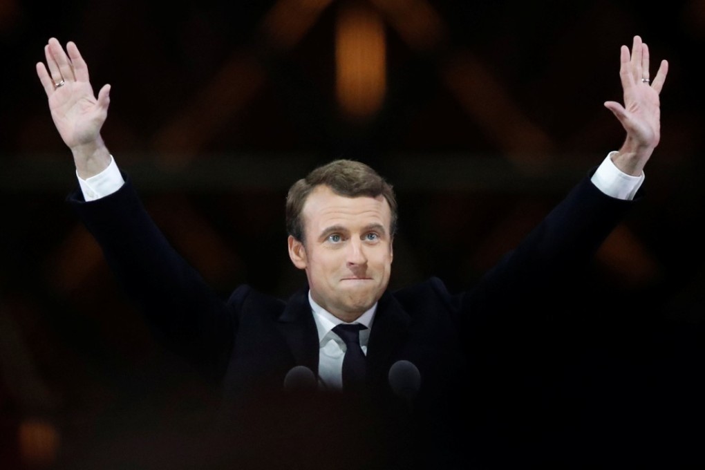 French president-elect Emmanuel Macron celebrates on stage at his victory rally near the Louvre in Paris on Sunday. Photo: Reuters