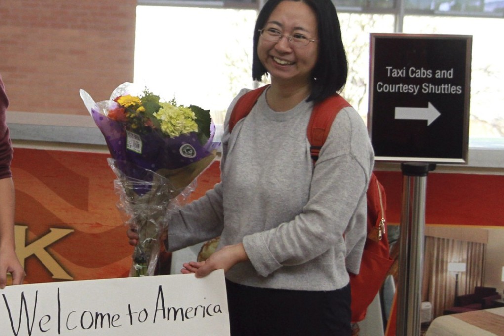 In this March 17, 2017, photo and released by China Aid, Chen Guiqiu holds a "Welcome to America" sign with her daughters after arriving at an airport in Texas. Chen whose husband, prominent rights lawyer Xie Yang, is held on charge of inciting subversion made a harrowing flight from China with her daughters chased by Chinese security agents across Southeast Asia. Photo: Associated Press / China Aid