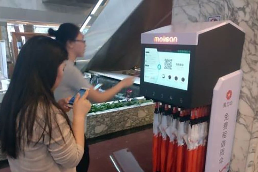 Commuters check out Molisan’s rented umbrellas at a Chinese subway station. Photo: Handout