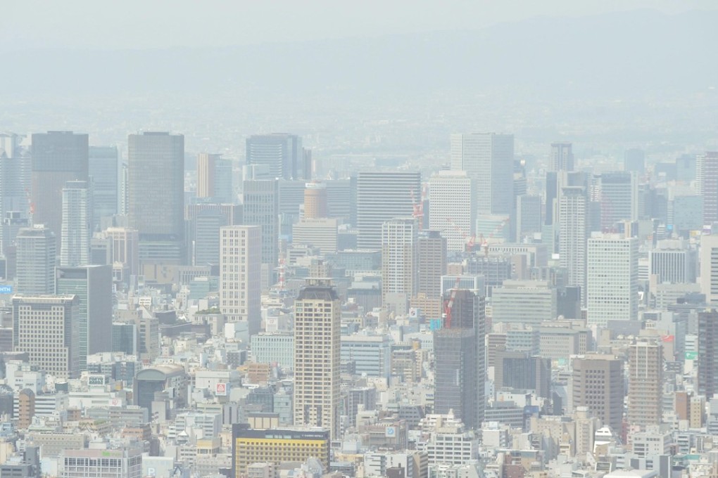 The air over the western Japanese city of Osaka is shrouded in yellow sand on Sunday. Photo: Kyodo