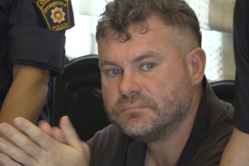 British national Jonathan Moorby, 47, is seen detained and questioned by police at his home in Koh Samui, Thailand. Photo: AP