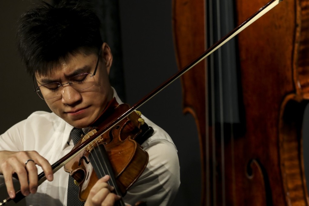 Vince Eliezer N. Chua, a master's degree student majoring in violin at The Hong Kong Academy for a Performing Arts (HKAPA), plays a rare 1684 violin known as the Ex-Croall; McEwen by Antonio Stradivari, estimated at HK$12-19 million, at Sotheby's Hong Kong office in Admiralty. Photo: Nora Tam