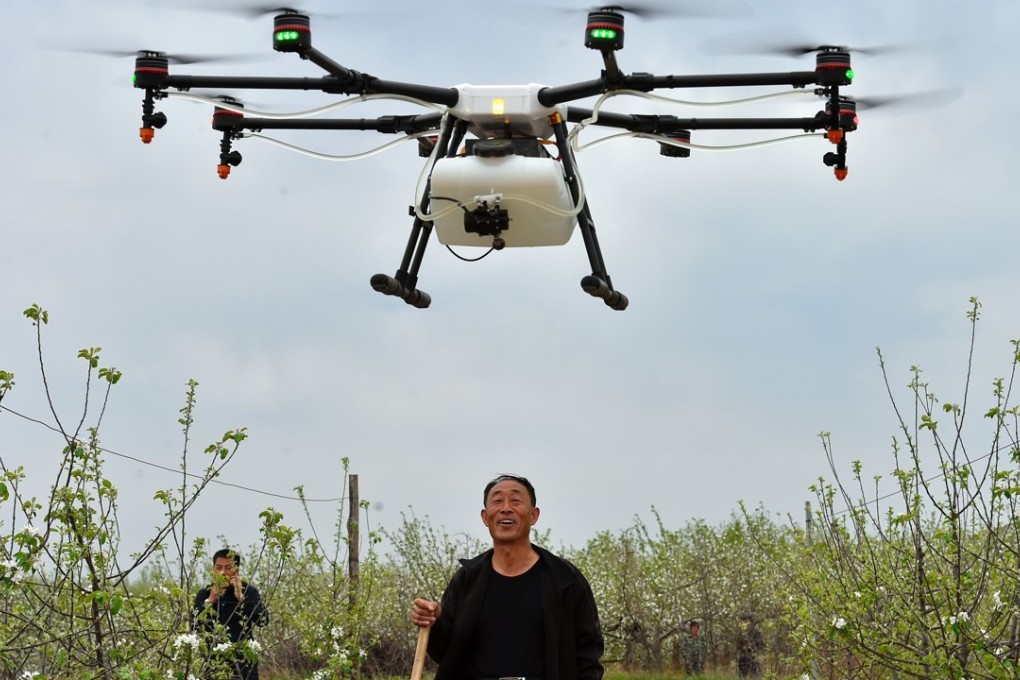 A farmer watches as a drone sprays pesticide in his field in Shanxi province. By 2025 agricultural and forestry drones are expected to be a 20 billion yuan market in China. Photo: Xinhua