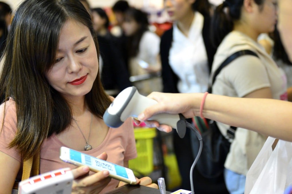 A customer pays with Alipay at a department store in Singapore. Photo: Xinhua